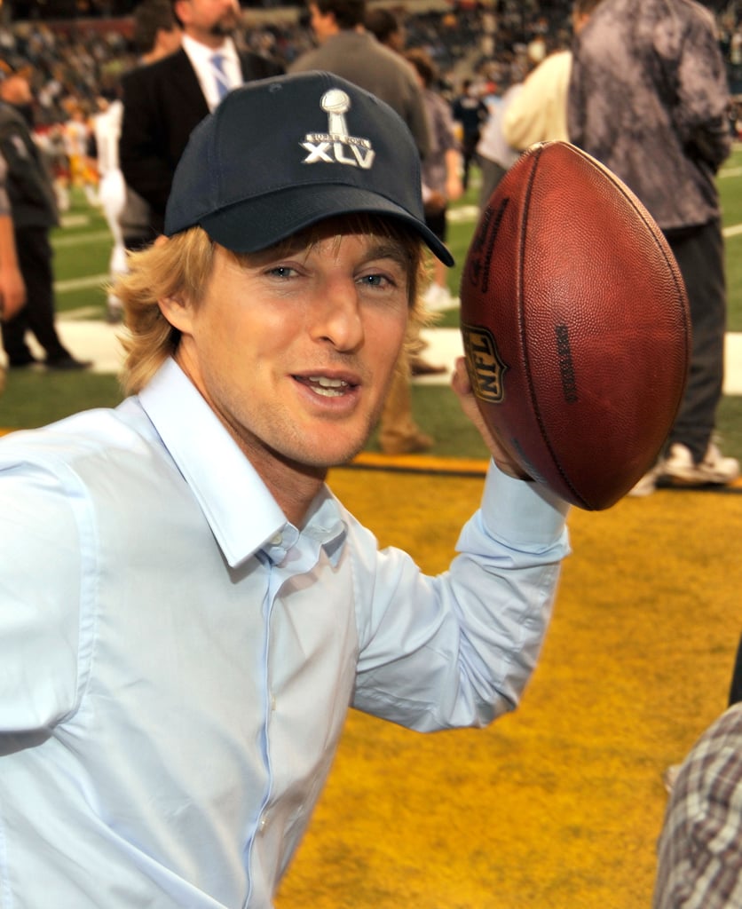 Owen Wilson posed with the pigskin on the sidelines in 2011.