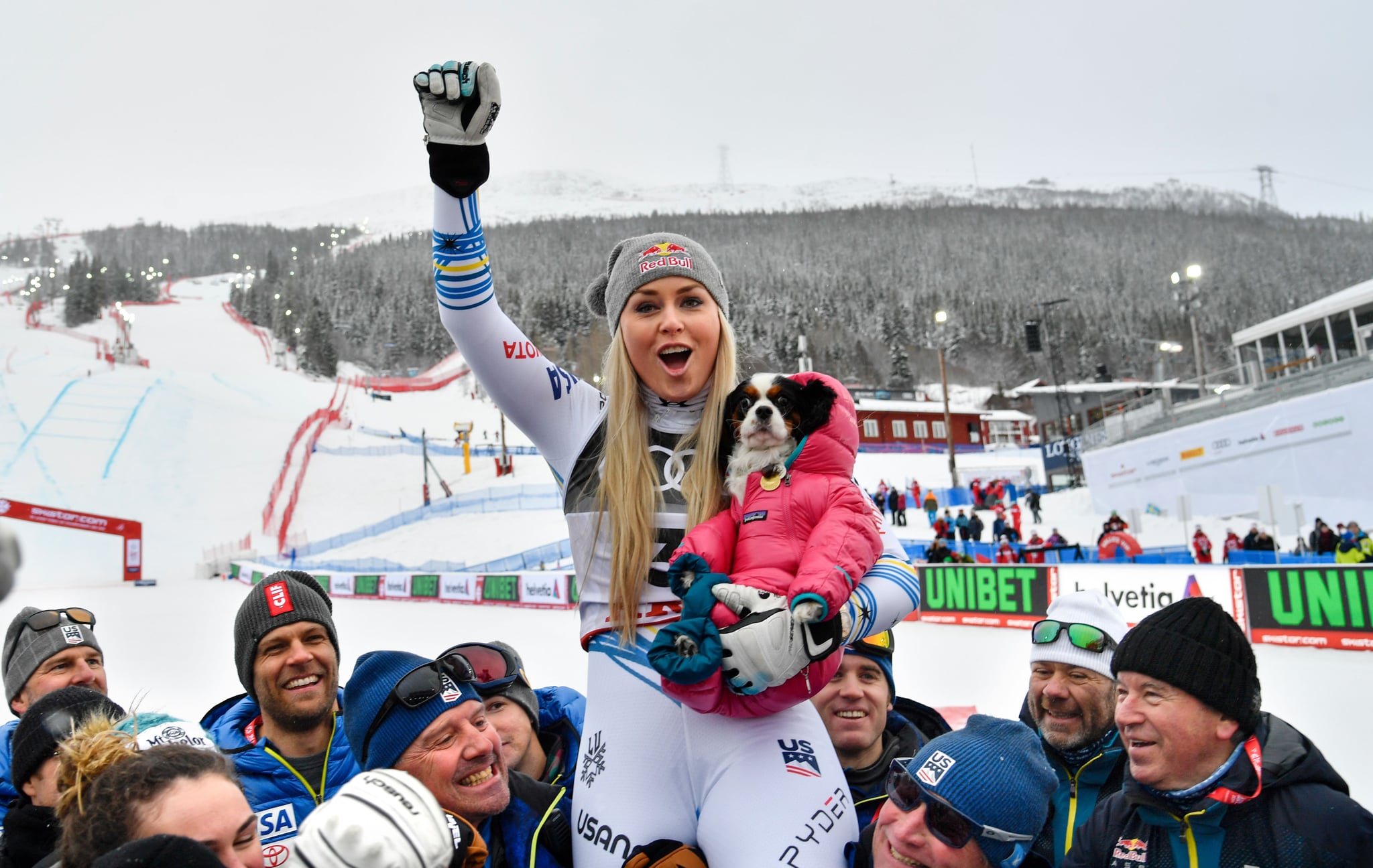 Third placed US' Lindsey Vonn celebrates with the US team and her dog Lucy after the Women's Downhill event of the 2019 FIS Alpine Ski World Championships at the National Arena in Are, Sweden on February 10, 2019. - Vonn, 34, who will retire from competitive skiing, is the most successful women skier of all time, with a record 20 World Cup titles to her name and 82 victories on the circuit. (Photo by Anders WIKLUND / TT News Agency / AFP) / Sweden OUT        (Photo credit should read ANDERS WIKLUND/AFP via Getty Images)