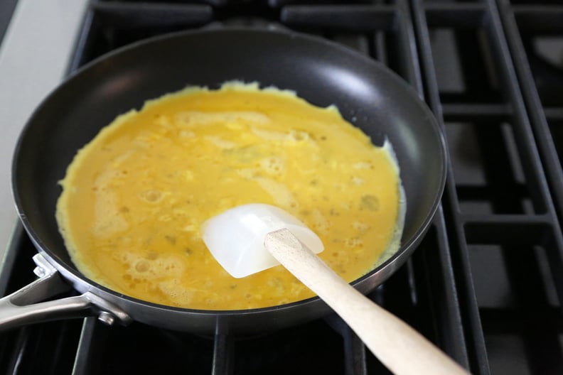 Whisk with one hand and shake the pan vigorously with the other.