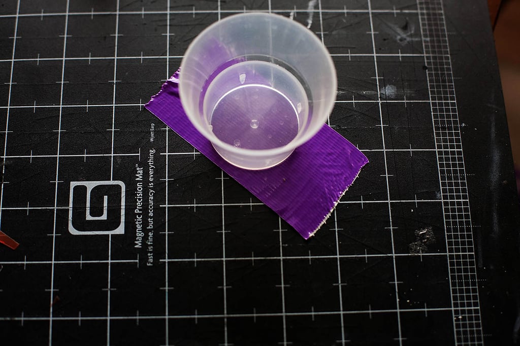 Using whatever you have lying around, cut two circles out of duct tape using the self-healing mat technique.
