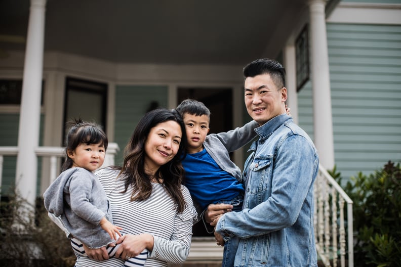 Portrait of family in front of home