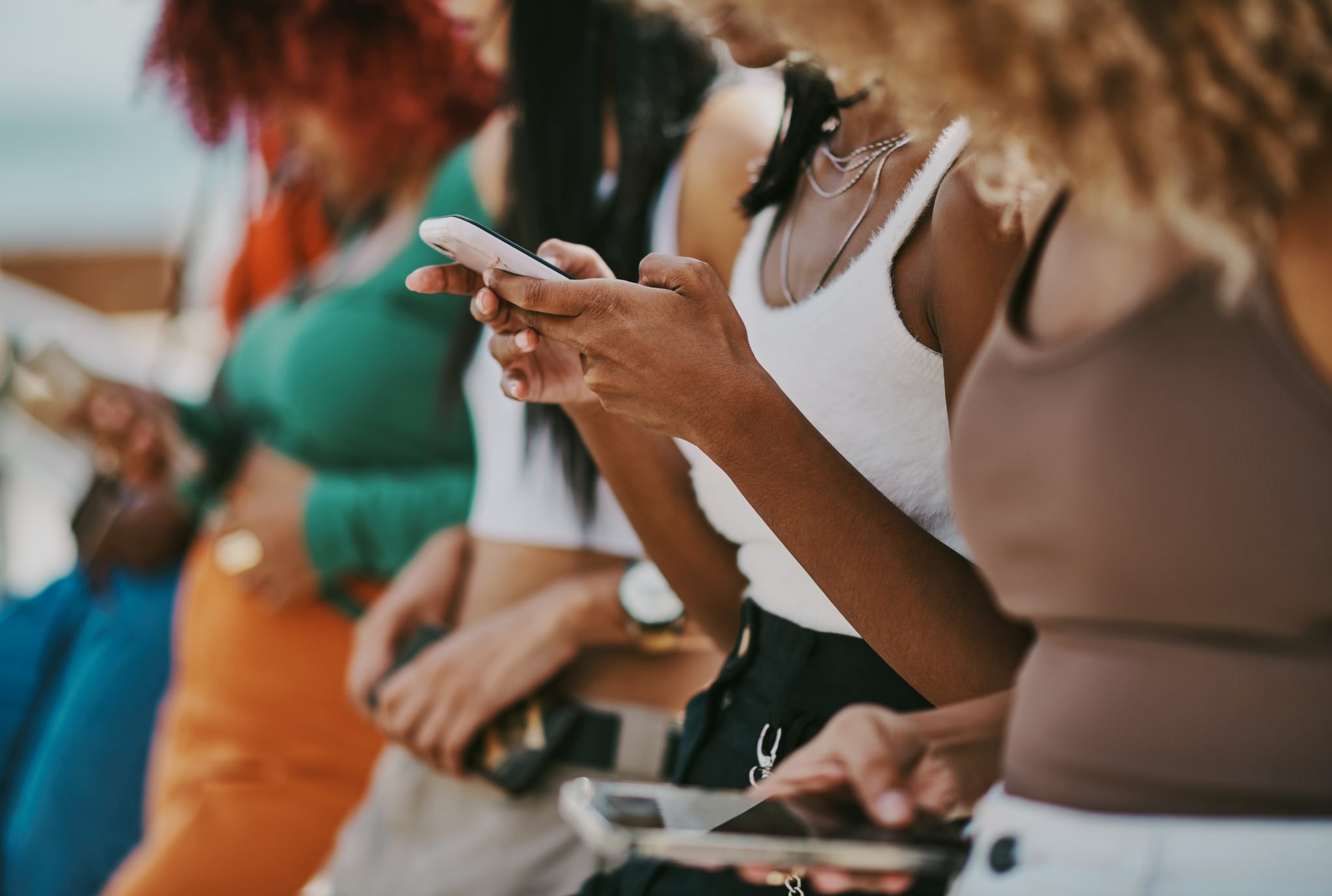 Variety of Bodies Looking at Phone
