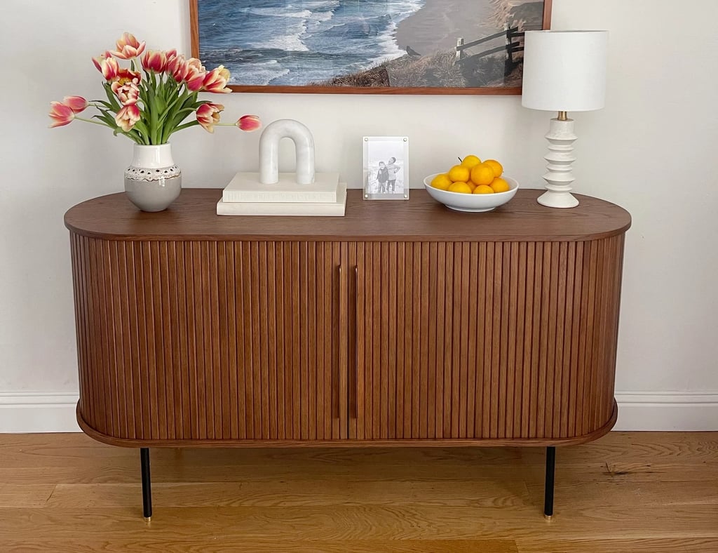Castlery Harper Sideboard ($1,399)
A midcentury-inspired stunner, this compact sideboard can conceal a surprising amount of stuff, from a tray filled with mail to bins for reusable shopping bags and dog leashes, all in a sleek package. Our editor has this piece in her dining room and was shocked by how much glassware and and extra dishes it held, freeing up tons of kitchen cabinet space. For more details, read this review of Castlery's Harper Sideboard.
Editor Quote: "I was a little worried that its compact size meant storage would be pretty limited, but it's deceptively spacious. Not only did I fit all of the china, but I also had two whole shelves on the opposite side to store napkins, glassware, and other barware." — Angela Elias former contributing shopping editor