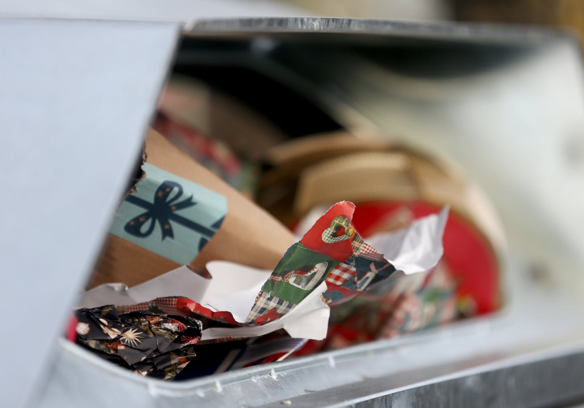 27 December 2018, North Rhine-Westphalia, Essen: A garbage container is filled to the brim with Christmas gift paper. If the wrapping paper is made of coated paper, it should be disposed of in the yellow bin. Photo: Roland Weihrauch/dpa (Photo by Roland Weihrauch/picture alliance via Getty Images)