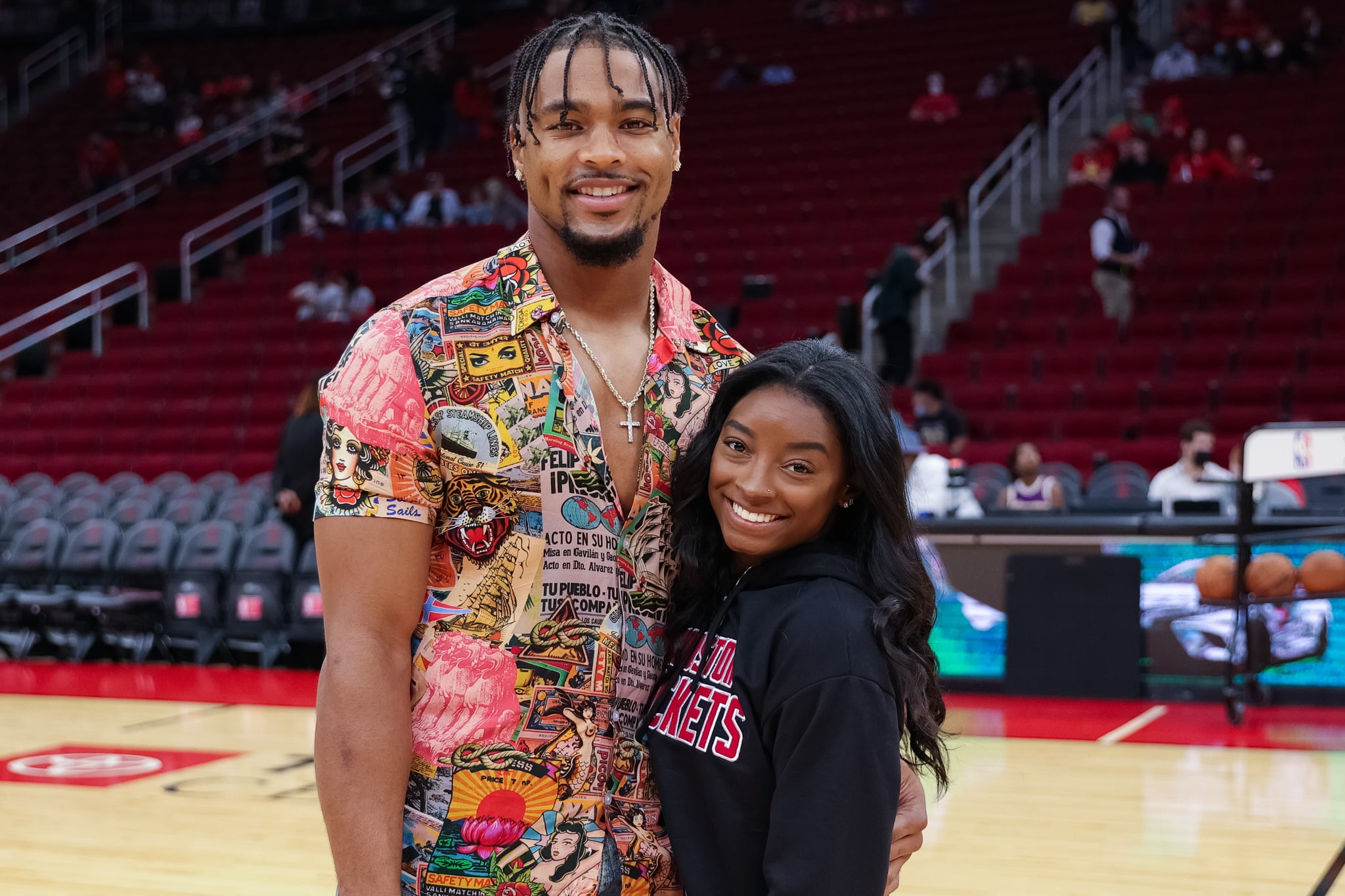 HOUSTON, TEXAS - DECEMBER 28: Simone Biles and Jonathan Owens attend a game between the Houston Rockets and the Los Angeles Lakers at Toyota Centre on December 28, 2021 in Houston, Texas. NOTE TO USER: User expressly acknowledges and agrees that, by downloading and or using this photograph, User is consenting to the terms and conditions of the Getty Images Licence Agreement. (Photo by Carmen Mandato/Getty Images)