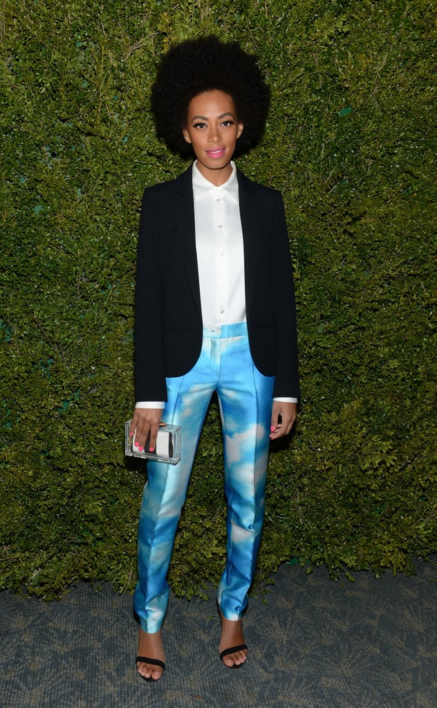 Solange Knowles amped up her cloud-print Michael Kors pants with a structured blazer and striped lucite Alice + Olivia clutch at a Michael Kors event in LA.