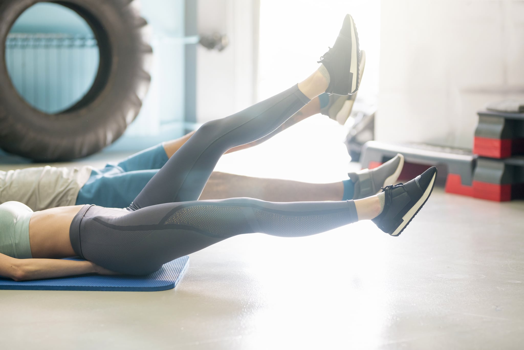 Unrecognisable, young heterosexual couple doing a core workout at the gym.