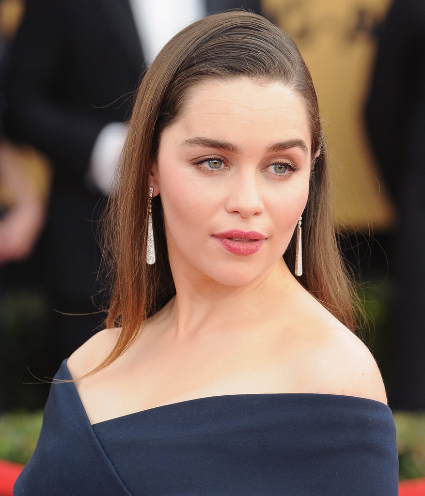 Emilia Clarke's long Cartier drop earrings complemented her sleek red carpet look.