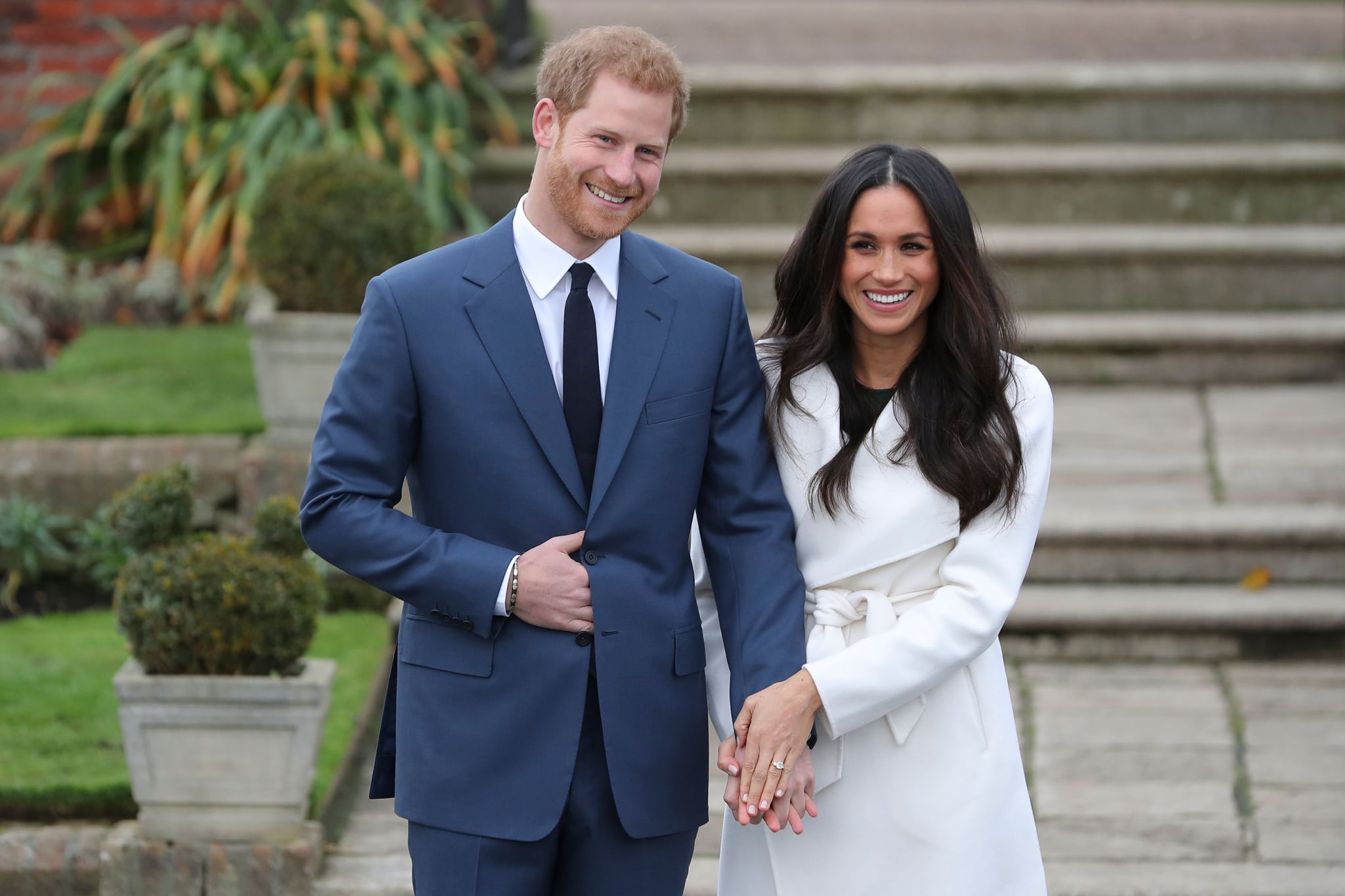 Britain's Prince Harry and his fiancée US actress Meghan Markle pose for a photograph in the Sunken Garden at Kensington Palace in west London on November 27, 2017, following the announcement of their engagement.Britain's Prince Harry will marry his US actress girlfriend Meghan Markle early next year after the couple became engaged earlier this month, Clarence House announced on Monday. / AFP PHOTO / Daniel LEAL-OLIVAS        (Photo credit should read DANIEL LEAL-OLIVAS/AFP/Getty Images)