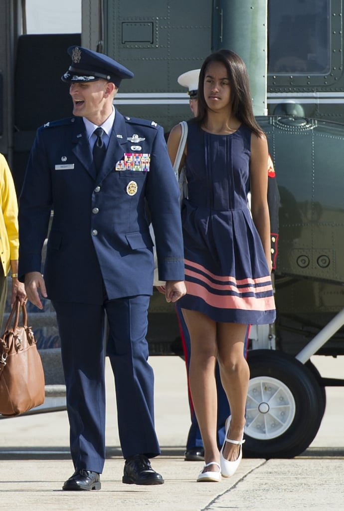Wearing a navy tank dress with salmon stripes.