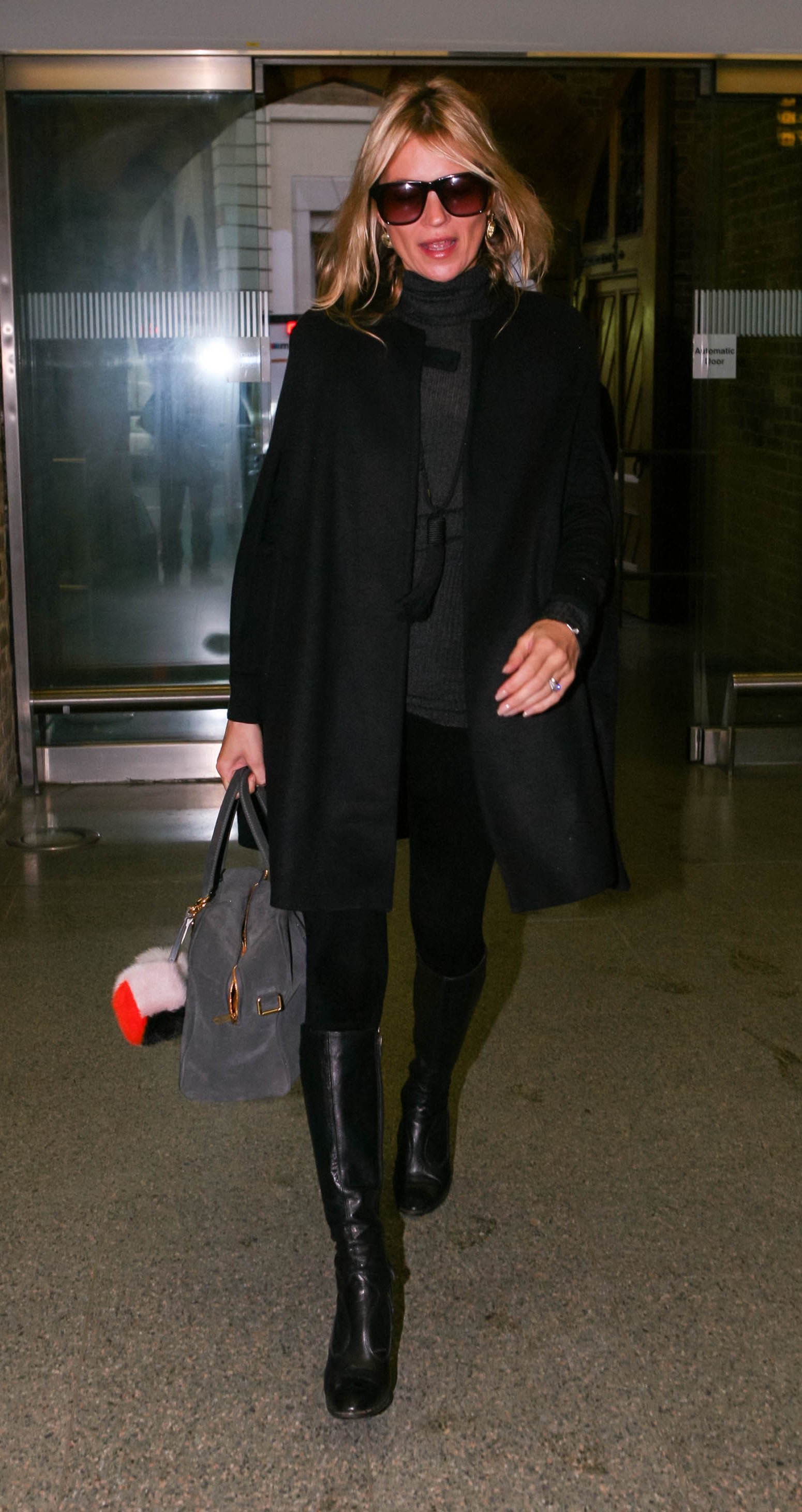 At the London Eurostar Terminal, en route to Paris, Kate looked polished and chic in all black, including knee-high boots and a peacoat.