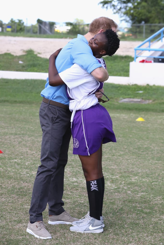 Harry hugged a young participant in a youth sports festival at Antigua's Sir Vivian Richards Stadium in 2016.