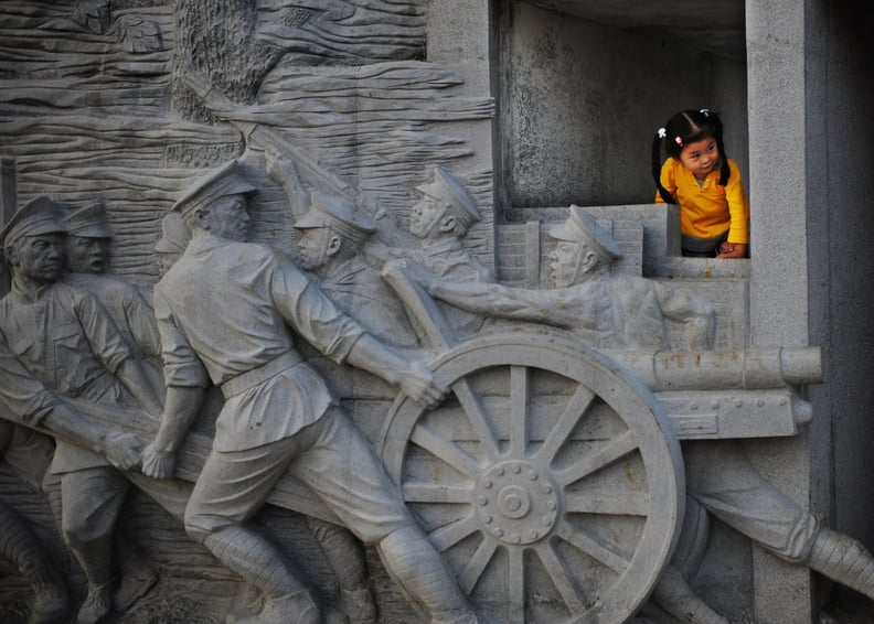 WUHAN, CHINA - OCTOBER 8: (CHINA OUT) A girl plays near the Gate of Wuchang Uprising renovated recently as part to mark the upcoming 100th anniversary of Wuchang Uprising October 8, 2011 in Wuhan of Hubei Province, China. This year marks the 100th anniver