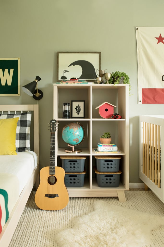 After we ditched the big media cabinet that was shoved against the far left wall, there was plenty of room to fit our convertible crib ($360, originally $400) and upgrade our toddler to a twin bed ($400). This cubby bookcase ($250) is even taller than our Ikea toy storage piece and can fit everything from toys to books.