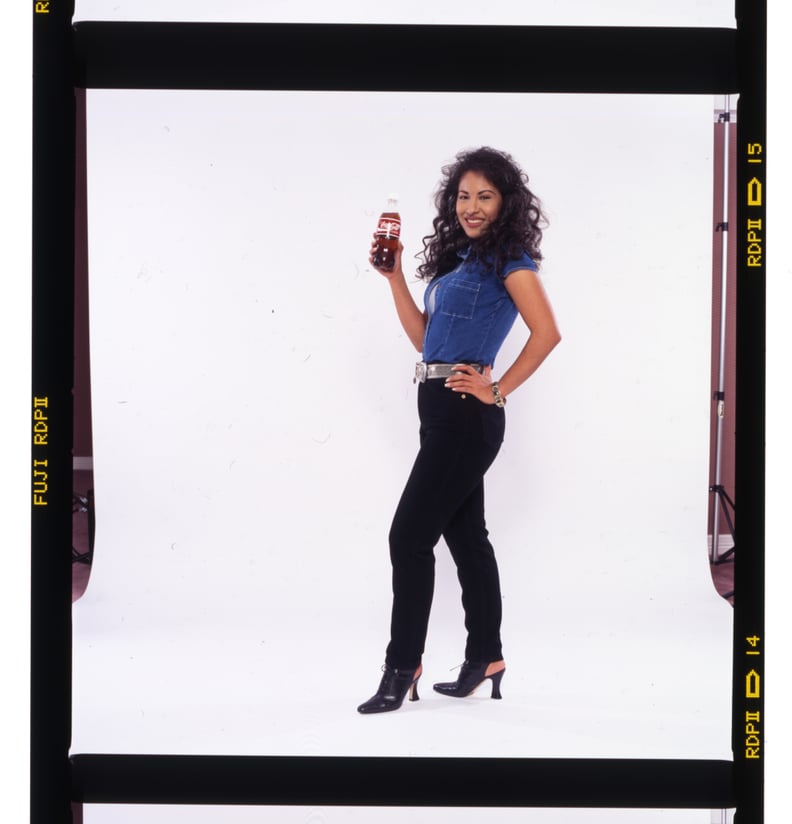 Selena in Black Denim Pants and a Blue Shirt For a Coca-Cola Campaign in 1994