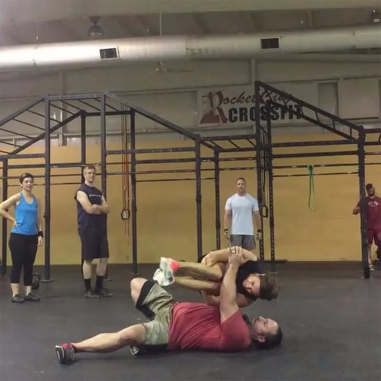 Man Does Turkish Get-Ups Holding a Woman