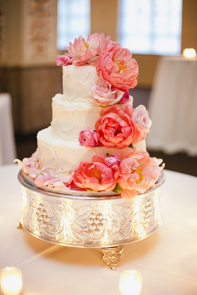 One easy way to make your cake feel supergirlie and sweet (aside from cascading flowers, of course)? A silver or gold cake stand that's just as detailed. 
Photo by Annabella Charles Photography via Style Me Pretty