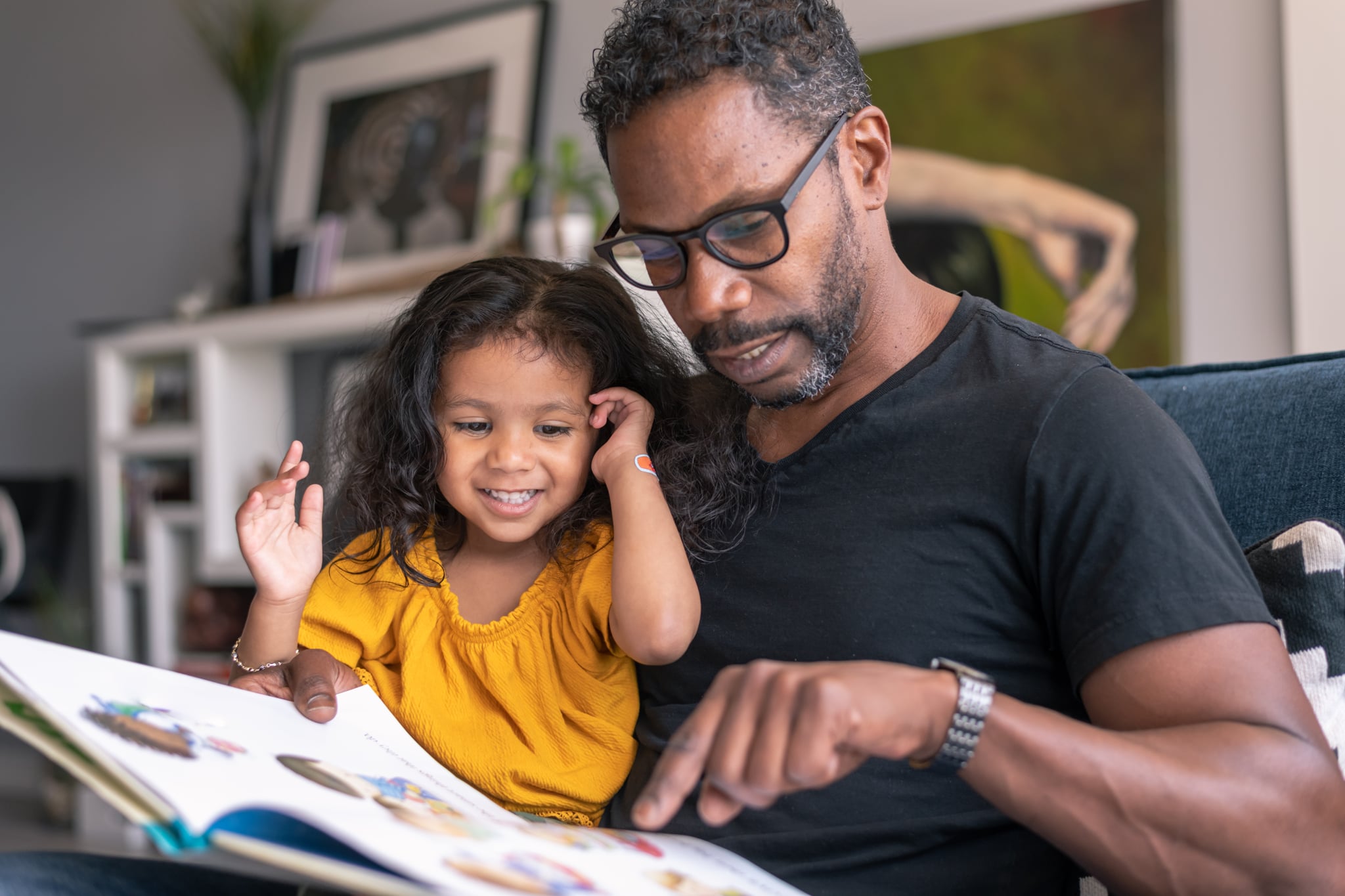 Father and daughter read together. 