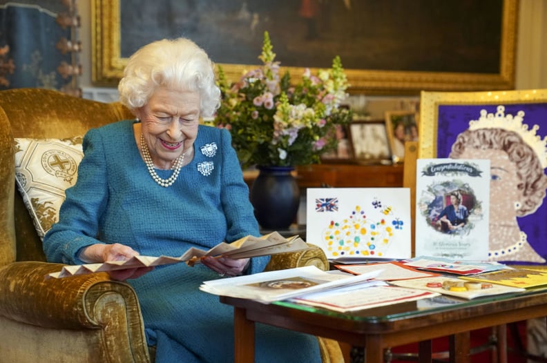 Queen Elizabeth looks at Golden and Platinum Jubilee memorabilia in February 2022.