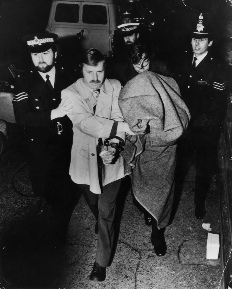 Police leading murderer Peter Sutcliffe, known as the Yorkshire Ripper, into Dewsbury Court under a blanket.   (Photo by Keystone/Getty Images)