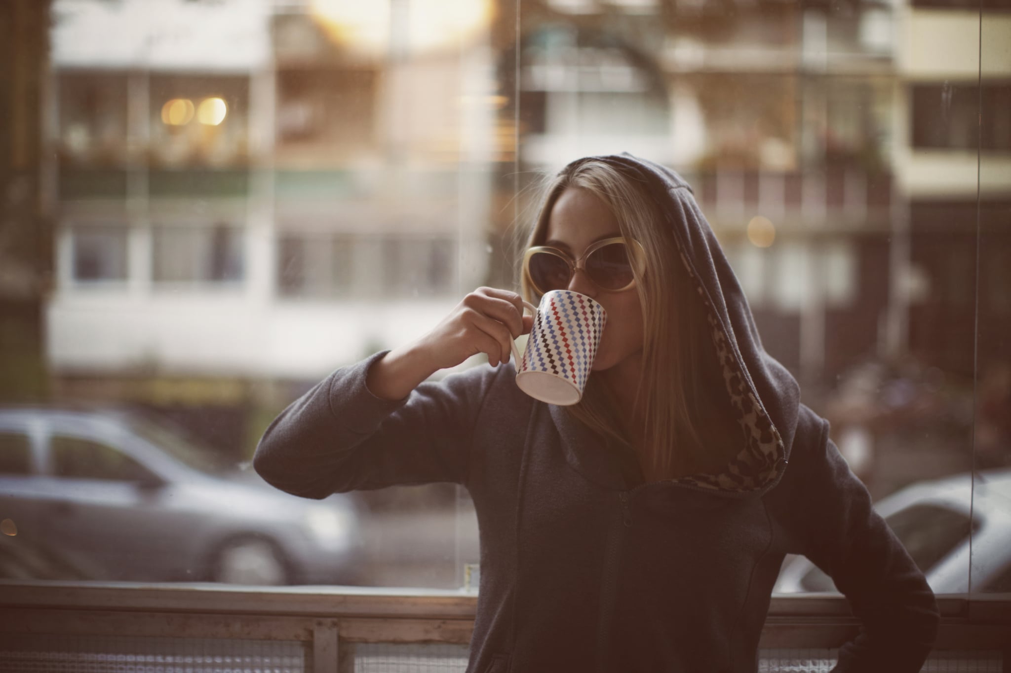 Young woman drinking late morning coffee.