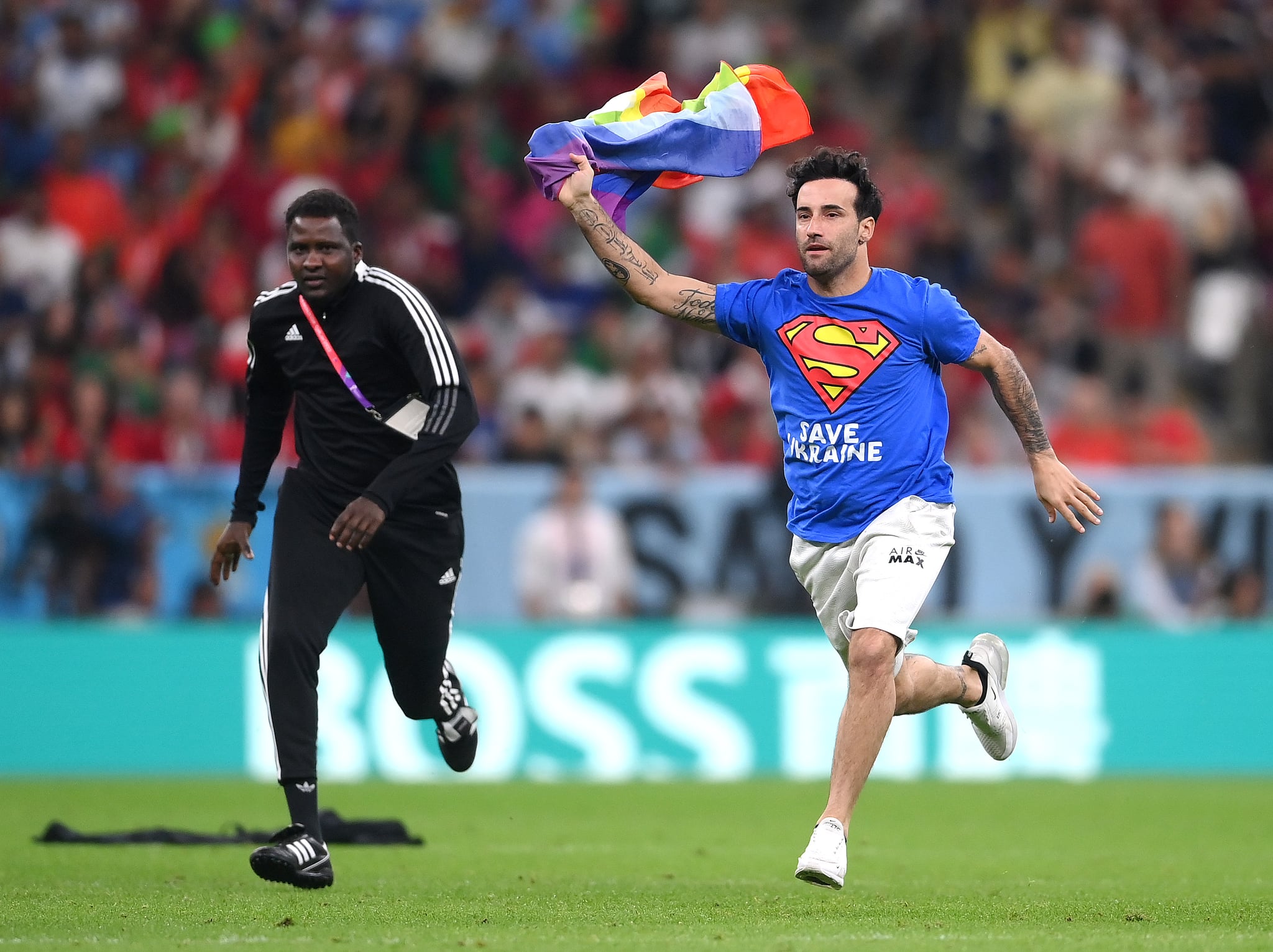 LUSAIL CITY, QATAR - NOVEMBER 28: A pitch invader wearing a shirt reading 