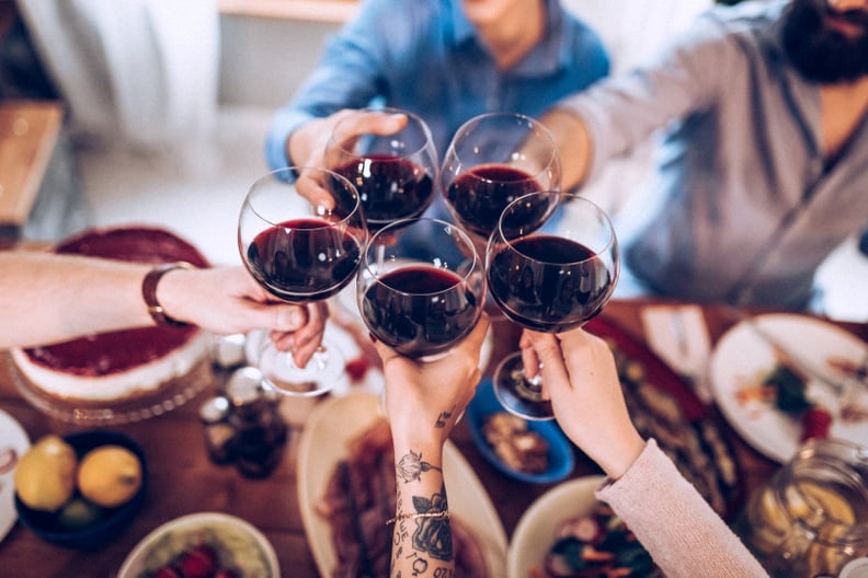 Five people drinking wine after dinner