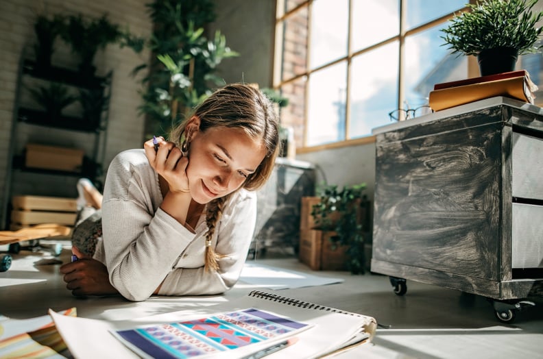 Woman coloring with a marker at home