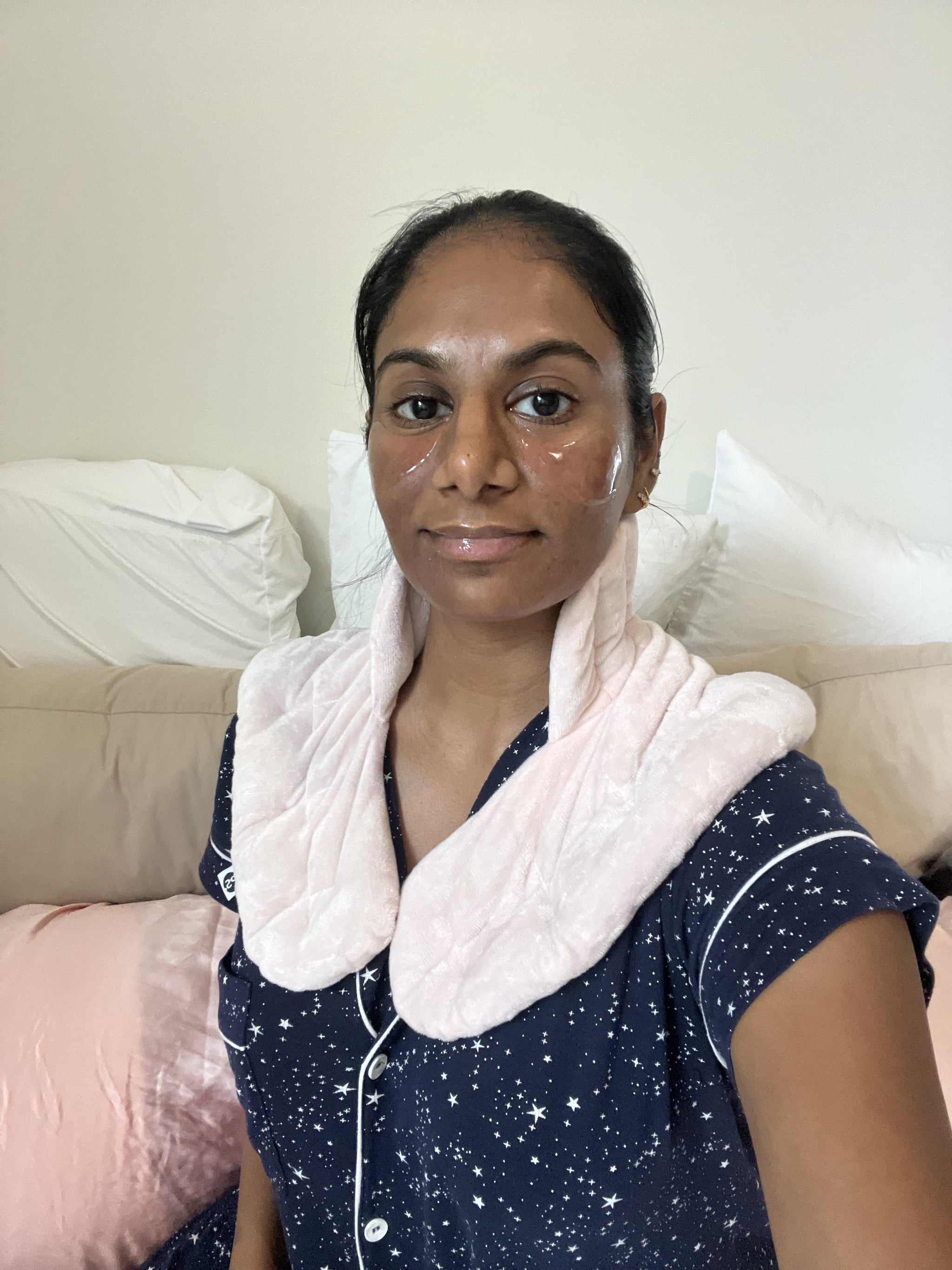 Woman wearing the PS Weighted Hot & Cold Neck Wrap Pillow on her neck and shoulders.
