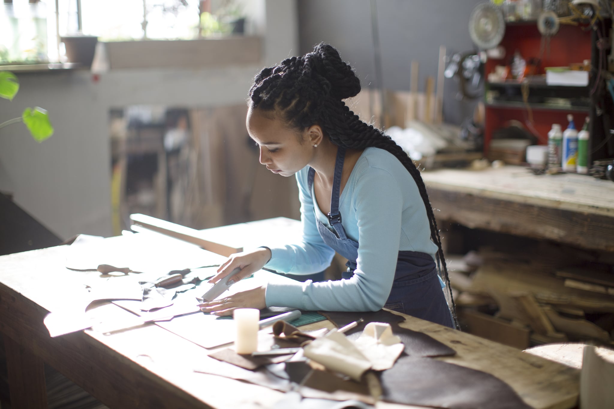 Craftsman working with leather in their workshop