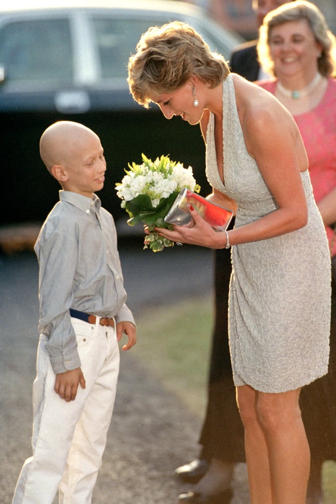Diana accepted flowers from a young boy at the Serpentine Gallery Summer Party in June 1995.