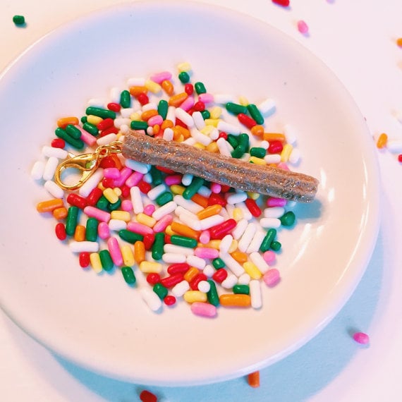 You can add this little charm to anything: a keychain, necklace, bracelet, or even a bag. 
Churro Charm ($10)