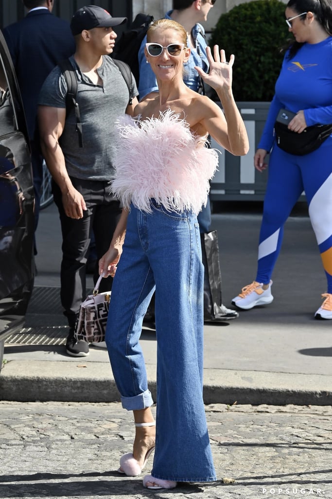 Even exiting her hotel was cause for a statement-making outfit; this one included a feathered Attico confection on top and a pair of asymmetrical jeans, paired with cat-eye shades and a Fendi handbag.