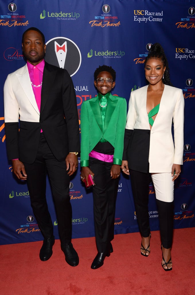 Zaya Wade made her red carpet debut alongside Dwyane Wade and Gabrielle Union on Saturday at the 2020 Truth Awards in Los Angeles, and the family's color-coordinated outfits were more than just stylish. All three of their bespoke Richfresh suits incorporated the colors of the genderqueer and nonbinary pride flag — lavender, white, and green — in support of 12-year-old Zaya's recent decision to publicly come out as transgender. 
"The Truth Awards was created to recognize and highlight the accomplishments of the Black LGBTQ+ community and its allies."
"Everyone allow her to re-introduce herself — her name is Zaya Wade!" Dwyane captioned an Instagram post sharing photos from the night. "Last night was Zaya's first red carpet and we couldn't have been prouder of how she handled the questions that were asked of her. She has emerged as one of the young faces and voices for the LGBTQ+ community . . . The Truth Awards was created to recognize and highlight the accomplishments of the Black LGBTQ+ community and its allies. In doing so, they increase the awareness of their contributions to Society, Popular Culture and the Arts, and help refocus the lens through which they are seen."
Zaya paired her emerald suit jacket and black pants with a bright lavender clutch and a silver chain-link necklace to match her dad's. Meanwhile, Dwyane and Gabrielle complemented Zaya's look with black and white suit jackets and a few pops of color underneath. In February, Zaya opened up about her identity and why it's important to her to be herself completely. "What's the point of being on this earth if you're gonna try to be someone you're not?" Zaya said in a video shared to her dad's Instagram account. "It's like you're not even living as yourself. Just be true and don't care what the stereotypical way of being you is."
According to Dwyane on Twitter, Zaya came up with the meaningful theme all on her own, and her involvement in choosing their outfits for the evening only made the event even more special. "It was important for Zaya to be a part of such a beautiful night and reminding her of all the love and support she has," Gabrielle wrote on Instagram. "We were moved to tears so many times throughout the night. So much gratitude." See more pictures of Dwyane, Zaya, and Gabrielle's powerful fashion statement ahead. 

    Related:

            
            
                                    
                            

            We Can&apos;t Get Enough of Dwyane Wade and Gabrielle Union&apos;s Family — See Their Best Photos