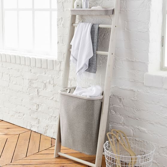 Wall leaning storage sales rack with hamper