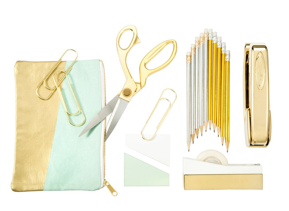 Metallic Accent Pencil Pouch ($9); 9.5" Gold Handle Scissors ($17); 10-Count Metallic Foil Wrapped Pencils ($5); 4-Count Gold Oversized Paper Clips ($3); Sticky Notes ($5); Gold Dipped Stapler ($16)