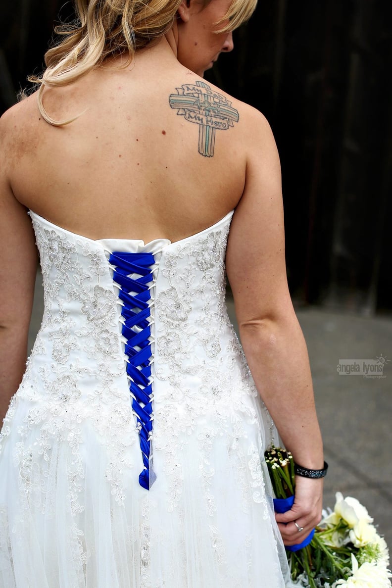 She wore a strapless gown that showed off her hero tattoo and "something blue" — a ribbon that represents the thin blue line.