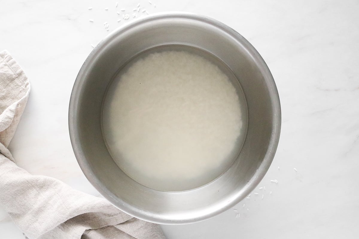 Rice and water in a large bowl