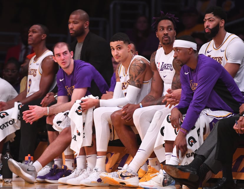 LOS ANGELES, CA - DECEMBER 22: Alex Caruso #4, Kyle Kuzma #0, Dwight Howard #39, Anthony Davis #3 and Kentavious Caldwell-Pope #1 of the Los Angeles Lakers sit on the bench in the fourth quarter of the game against the Denver Nuggets at Staples Center on 