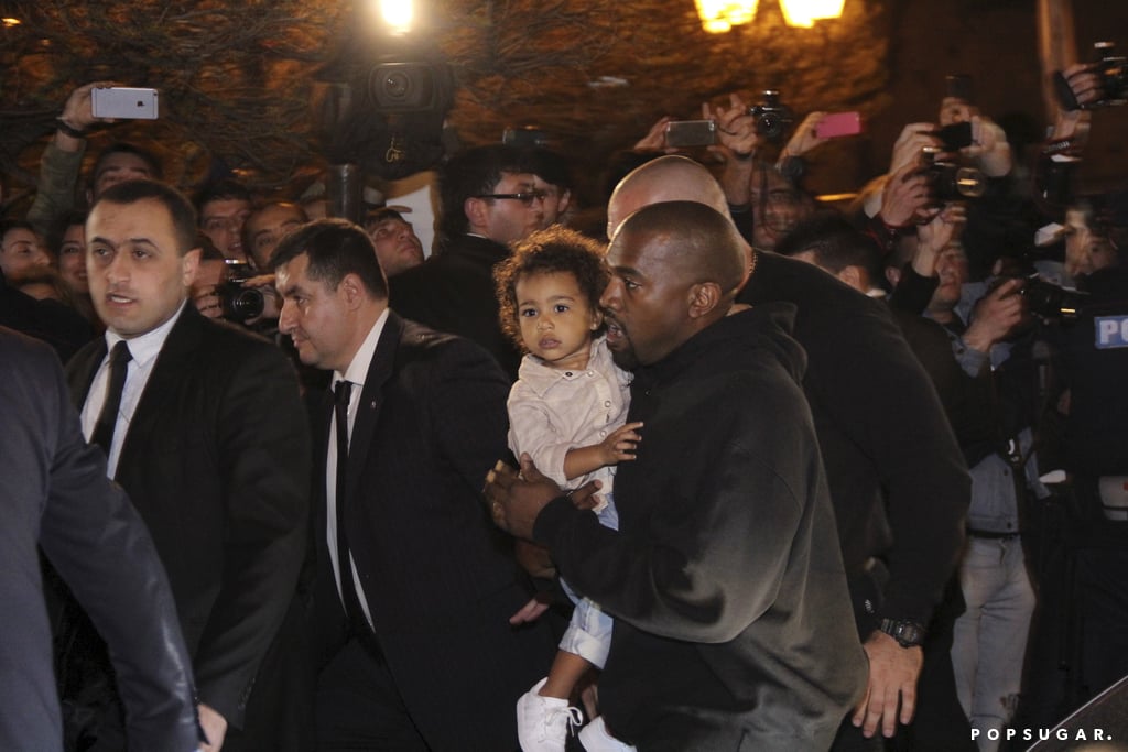 Kanye held North close as they made their way through the crowd.