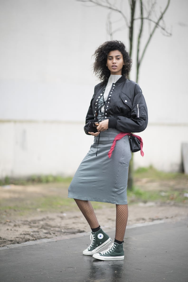 With a High-Neck Top, a Bomber Jacket, a Midi Skirt, and Fishnet Tights