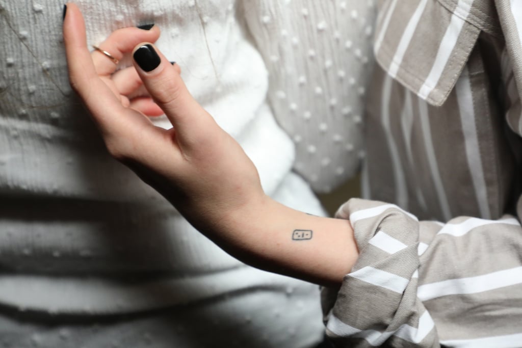 Also on her left wrist, but on the inner side, appears to be a tiny domino dice with the rolled numbers 1 and 2 shown atop. The design was first spotted in early 2018, but Stewart has not shared its meaning.