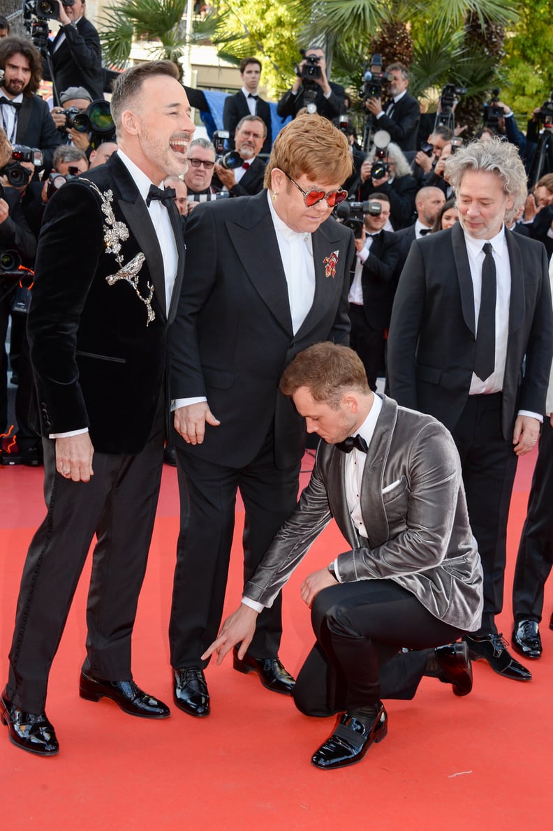 First, Taron Points Out Elton John's Untied Shoe