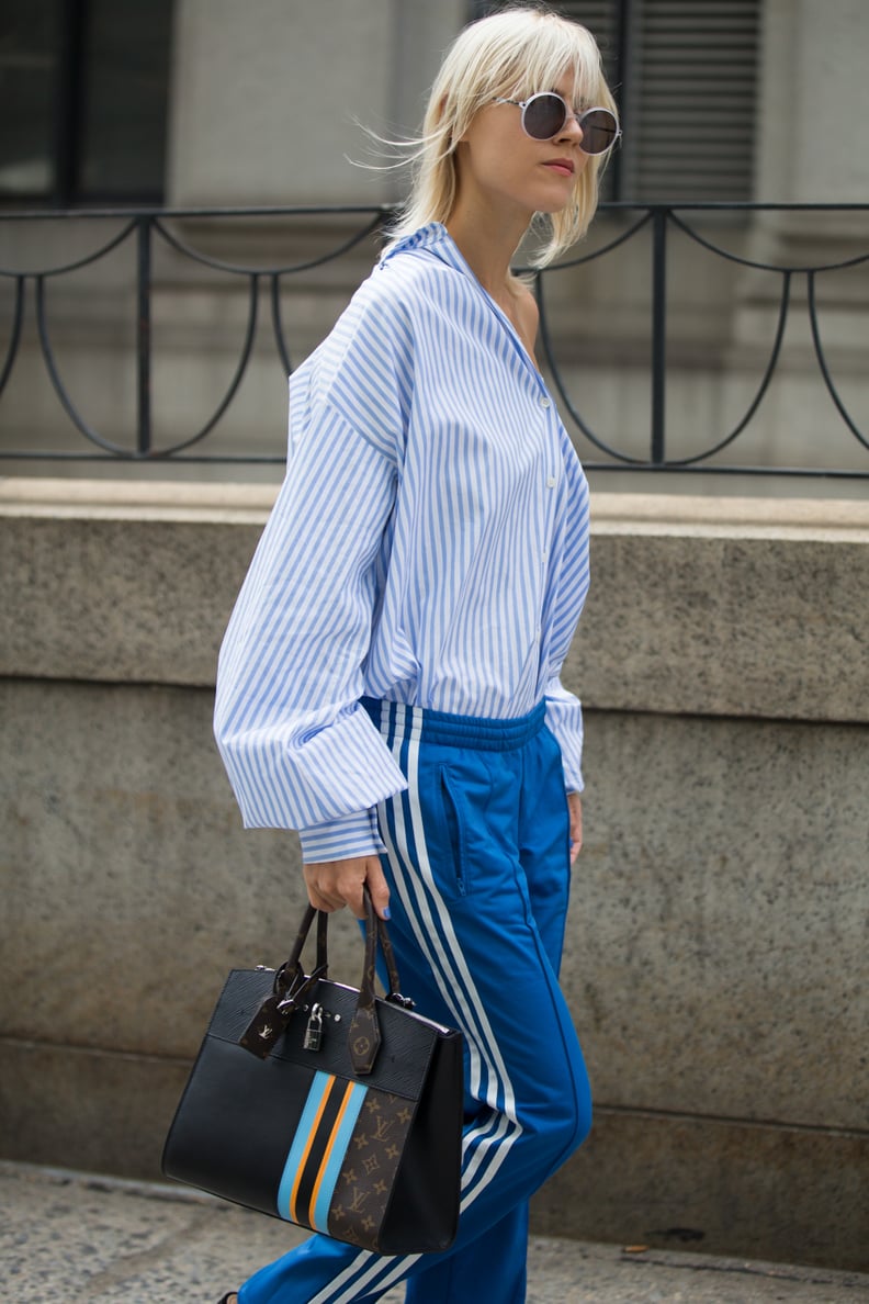 With a Shirt Twisted Off-the-Shoulder and a Designer Satchel