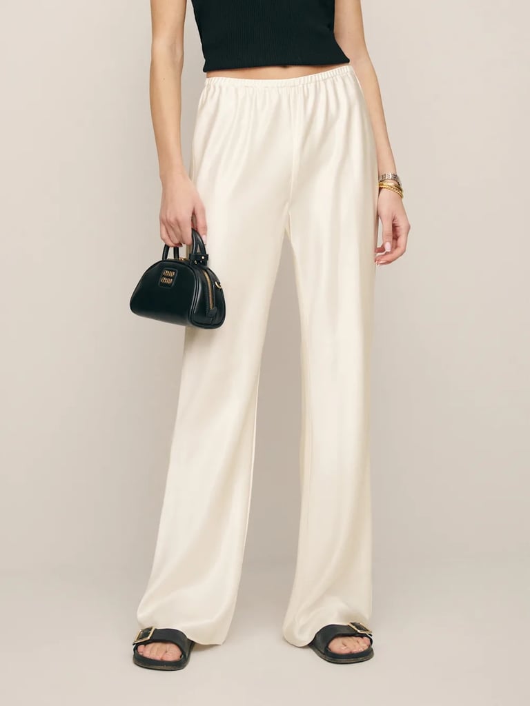 Gale Satin Mid Rise Bias Pant ($198)
Funny enough, I actually wore pajama pants that are no longer available to shop (sad), but these ones from Reformation are very similar — both in material and look — and would be a great alternative if you're going for a style like mine. I personally loved wearing a comfortable, lightweight pair of pants to the show (we're in Vegas, after all). You can grab them in other colors, too. If you're looking for other choices for your lower half, cargo pants were another popular pick.