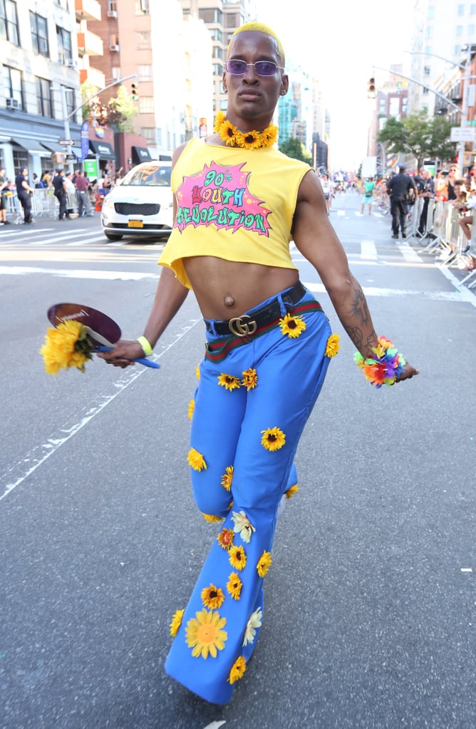 A guest wearing a cropped tee and sunflower appliqué pants with a Gucci belt.