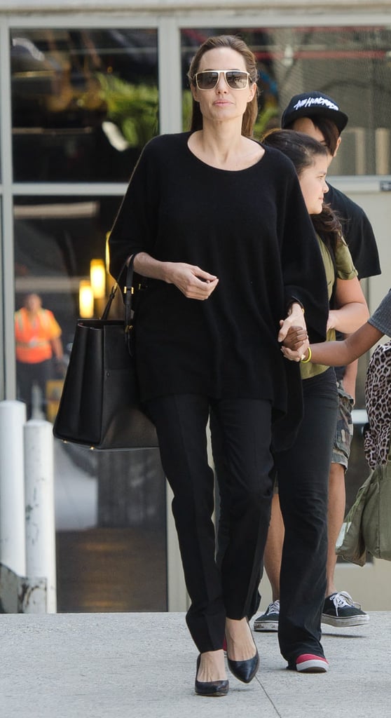 Wearing gold square-shaped sunglasses.