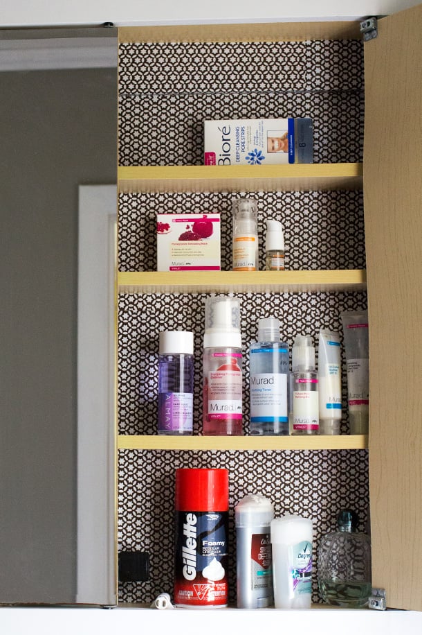 Line the medicine cabinet with decorative paper