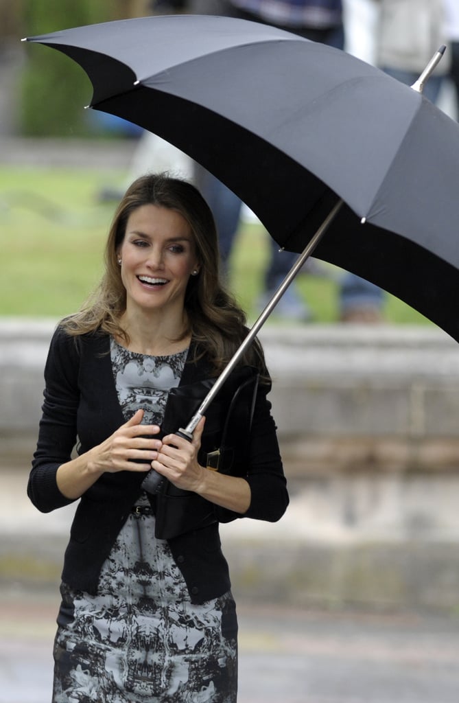 In October 2013, Letizia laughed while holding an umbrella outside an event in Oviedo, Spain.