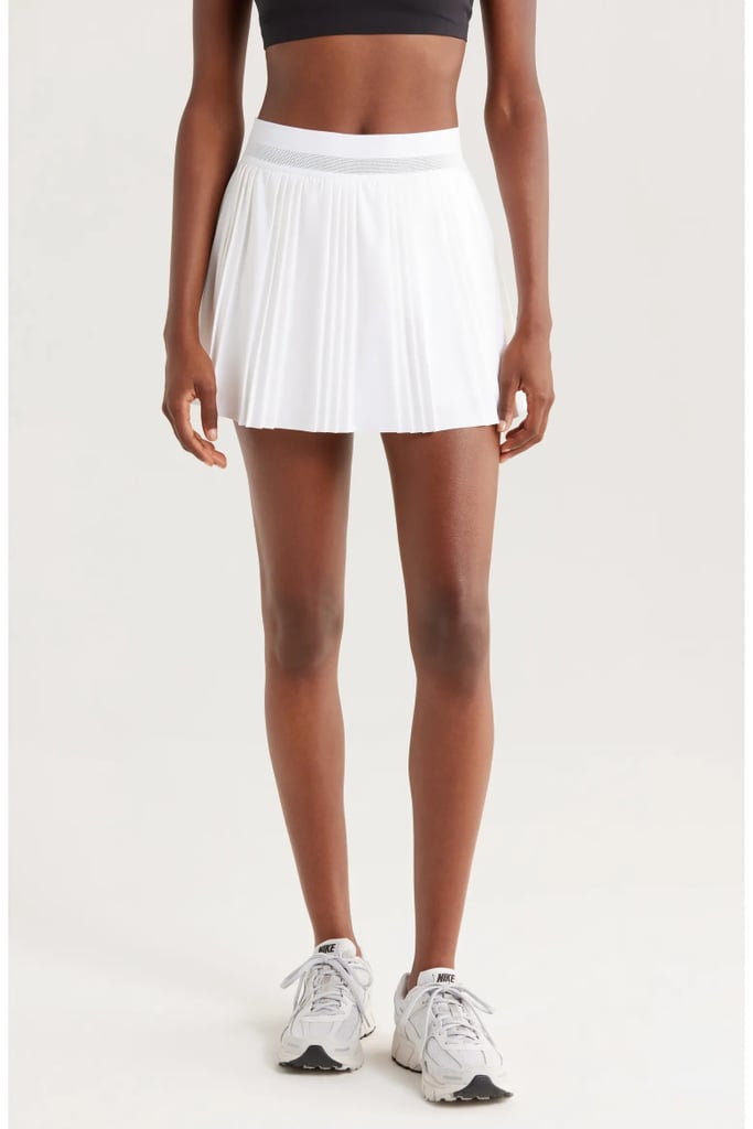 NikeCourt Advantage Dri-FIT Pleated Tennis Skort ($90)
When we think of tennis fashion we can't help but think of a fitted tennis skirt. Over the years, tennis skirts have evolved from basic skort silhouettes to pleated pieces that are equal parts stylish and practical. This Nike tennis skirt is loved for its built-in shorts, which help to prevent chafing and ensure full coverage through even the most intense matches.